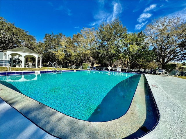 view of swimming pool with a gazebo and a patio area