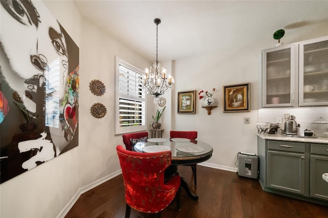 2539 Silverback Ct, Palm Harbor, FL 34684 - dining room featuring dark wood finished floors, baseboards, bar, and an inviting chandelier