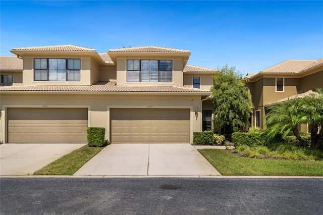 2539 Silverback Ct, Palm Harbor, FL 34684 - view of front of home with a tile roof, stucco siding, driveway, and a garage