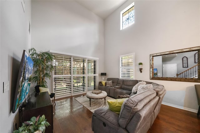 living room featuring dark hardwood / wood-style floors and high vaulted ceiling