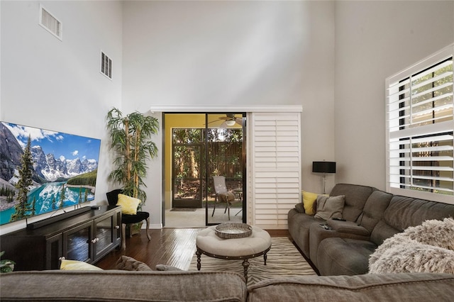 2539 Silverback Ct, Palm Harbor, FL 34684 - living area with visible vents, a high ceiling, wood finished floors, and a ceiling fan
