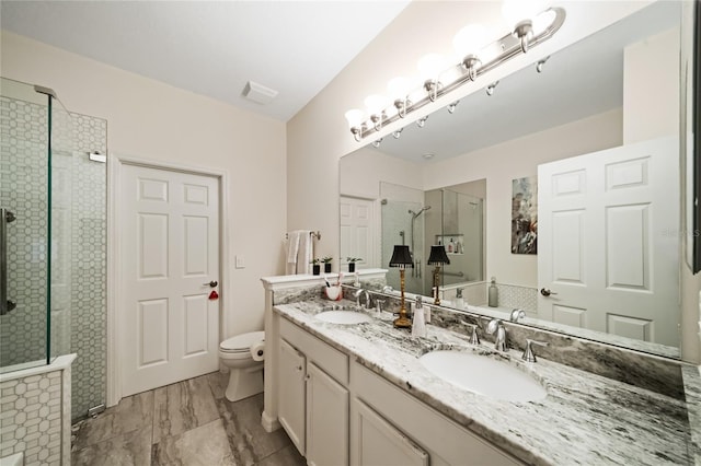 bathroom featuring walk in shower, vanity, and toilet