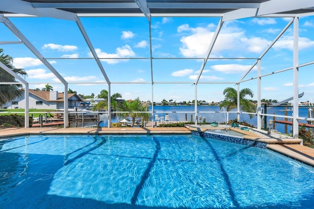 view of swimming pool featuring glass enclosure, a water view, and a patio