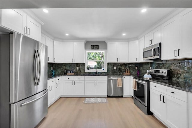 kitchen with white cabinetry, light hardwood / wood-style floors, and appliances with stainless steel finishes