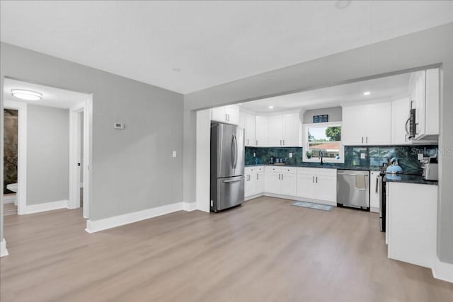 kitchen featuring light wood-type flooring, white cabinetry, and appliances with stainless steel finishes