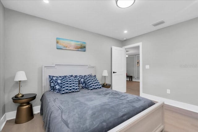 bedroom with hardwood / wood-style flooring