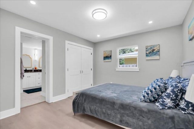 bedroom featuring a closet and ensuite bath