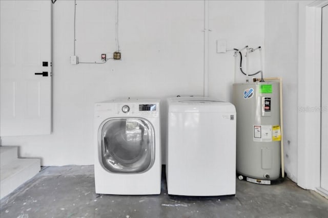 clothes washing area with separate washer and dryer and water heater