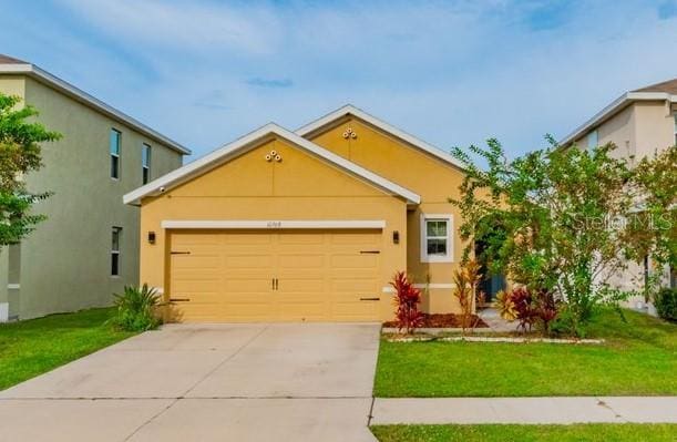 view of front of house with a garage and a front yard