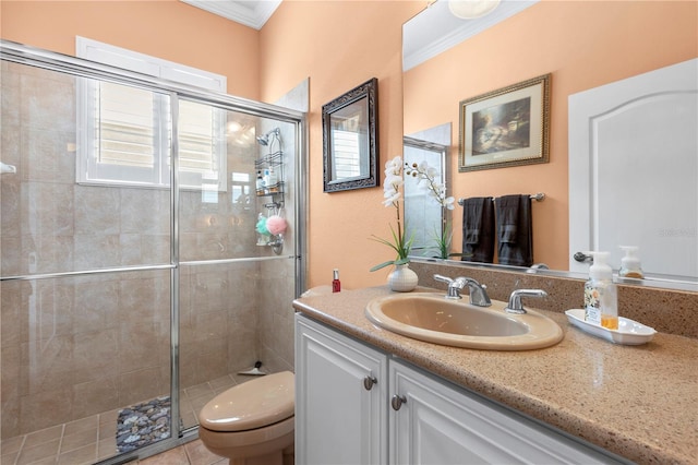 bathroom with vanity, toilet, walk in shower, and crown molding