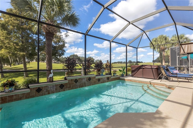 view of pool with glass enclosure, a patio area, and a hot tub