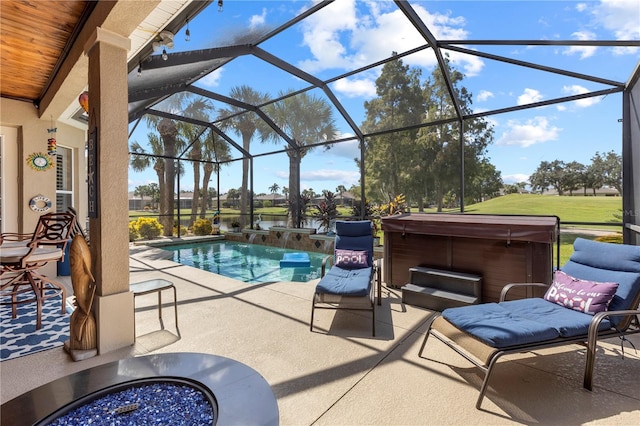 view of patio / terrace featuring a lanai and a swimming pool with hot tub