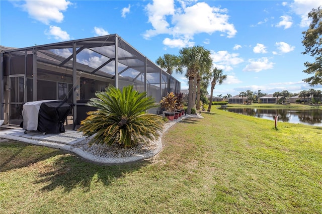 view of yard featuring glass enclosure and a water view