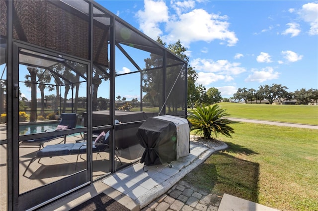 view of patio with glass enclosure and area for grilling