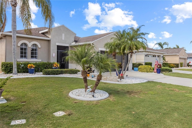 view of front of home with a front yard and a garage