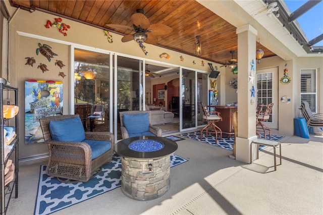 view of patio with an outdoor fire pit and ceiling fan