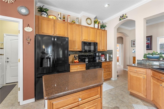 kitchen featuring backsplash, ornamental molding, black appliances, light tile patterned floors, and a center island