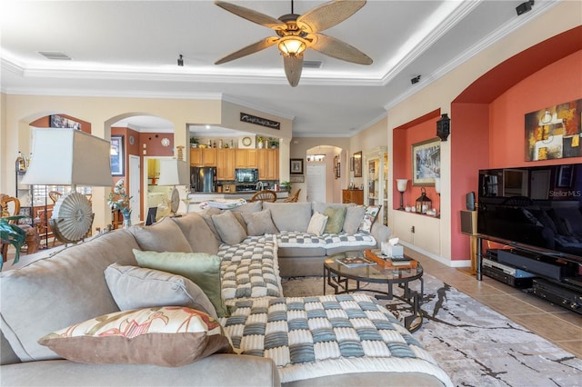 living room featuring light tile patterned floors, ceiling fan, and ornamental molding