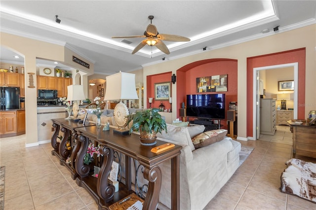 tiled living room featuring ceiling fan and ornamental molding