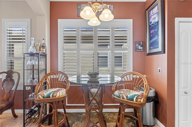 dining space featuring tile patterned floors, a chandelier, and a healthy amount of sunlight