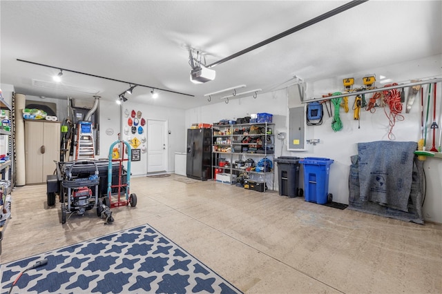 garage with electric panel, black fridge, and a garage door opener