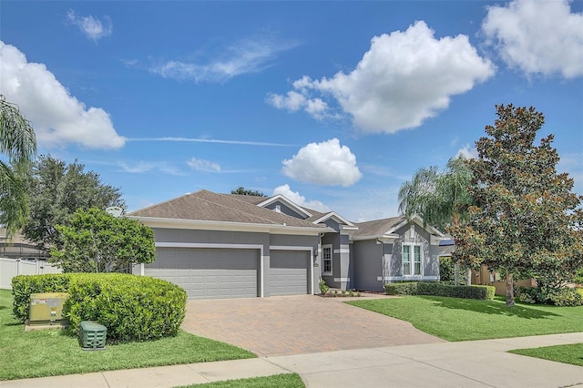 ranch-style home featuring a garage and a front yard