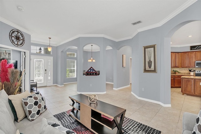 living room with crown molding, light tile patterned floors, and a chandelier