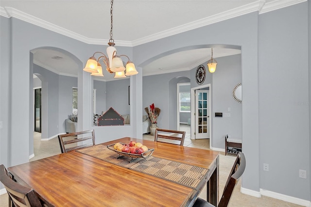 dining space featuring light tile patterned floors, crown molding, and a chandelier