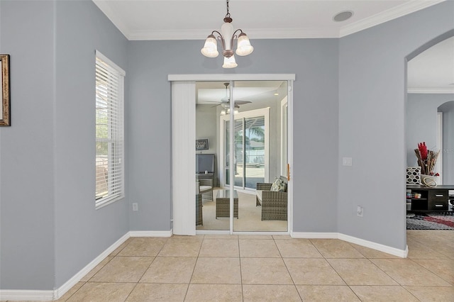 unfurnished dining area featuring ceiling fan with notable chandelier, ornamental molding, and light tile patterned floors