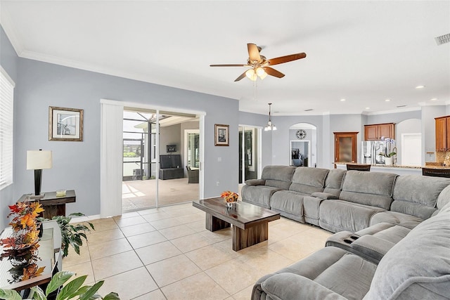 living room featuring light tile patterned floors, ornamental molding, and ceiling fan