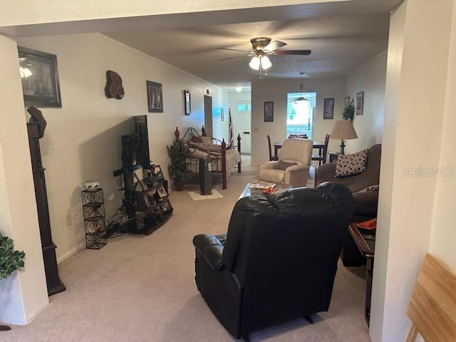 living room featuring ceiling fan and light colored carpet