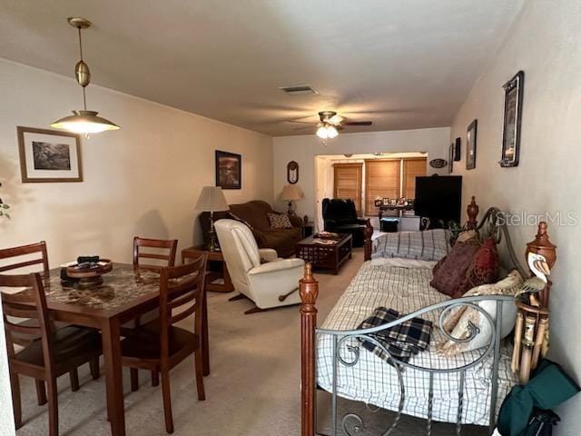 dining space with carpet floors and ceiling fan