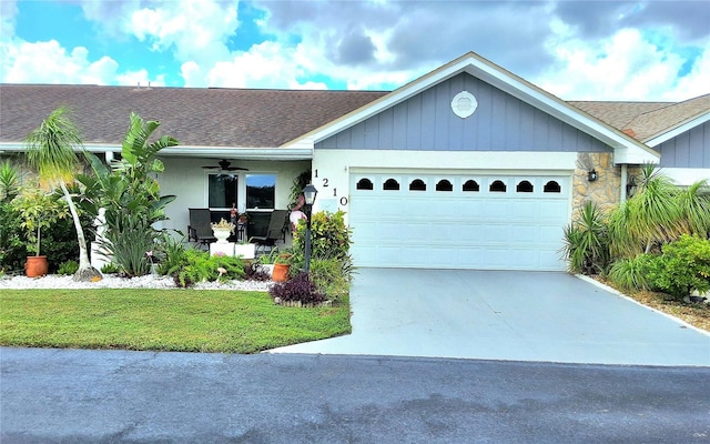 single story home with ceiling fan, a garage, and a front lawn