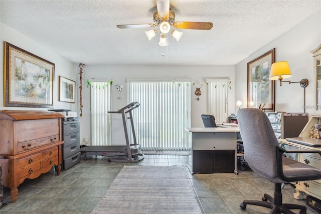 office area with dark tile patterned floors, a textured ceiling, and ceiling fan