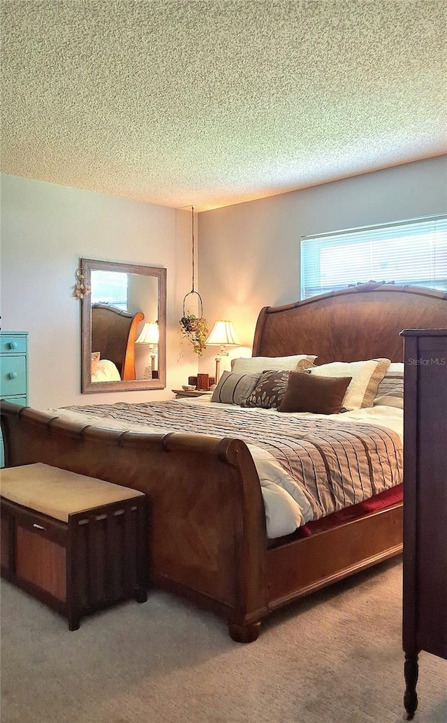 bedroom featuring light colored carpet and a textured ceiling