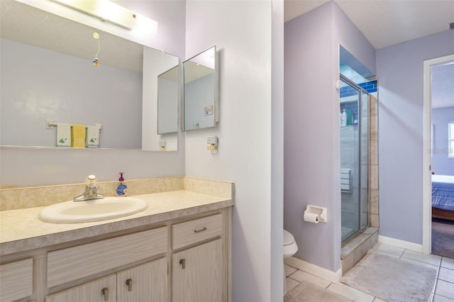 bathroom with vanity, walk in shower, a textured ceiling, tile patterned flooring, and toilet