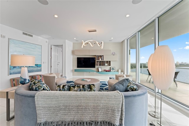 living room with a chandelier and expansive windows