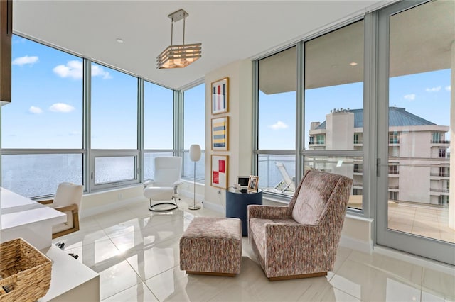 sunroom with a water view and a wealth of natural light