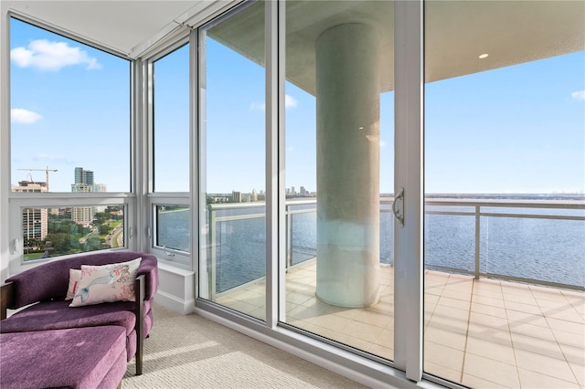 interior space featuring a wealth of natural light and a water view