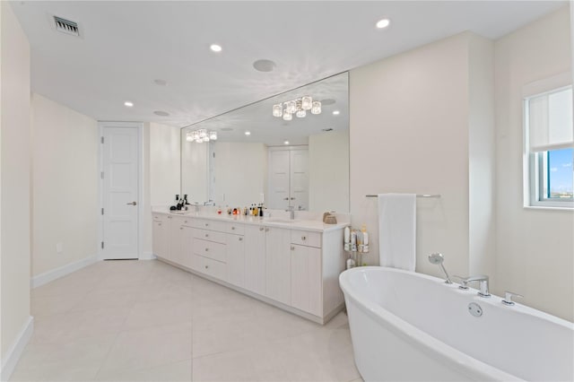 bathroom with tile patterned flooring, vanity, and a bathing tub