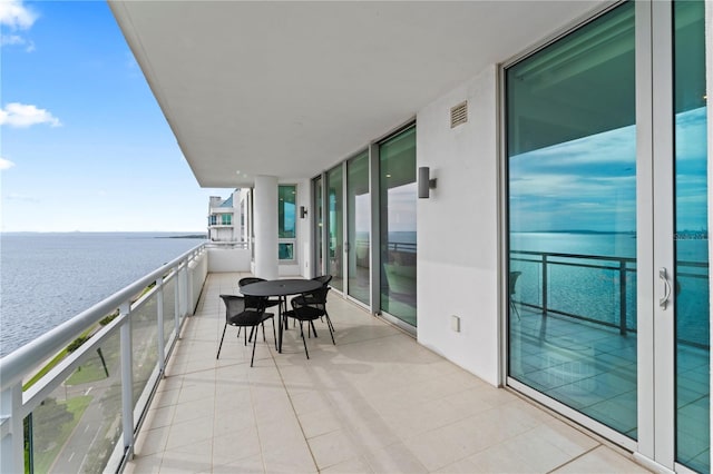 balcony with a water view and beverage cooler