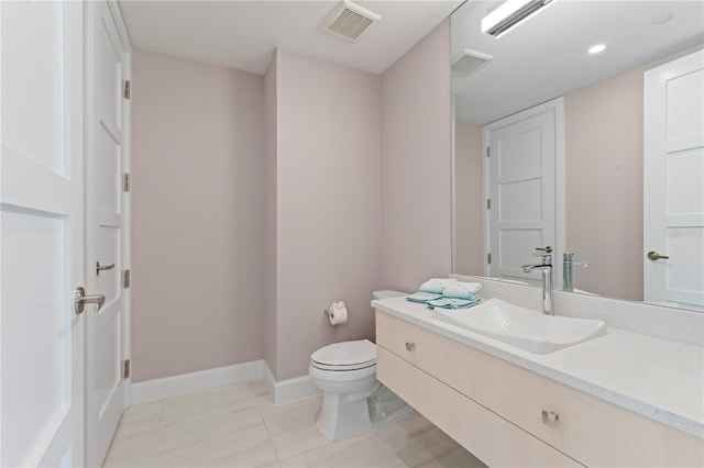 bathroom featuring tile patterned flooring, vanity, and toilet