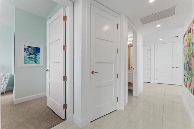 hallway with light carpet, baseboards, and recessed lighting