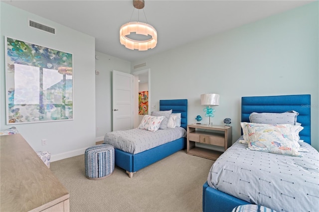 carpeted bedroom with baseboards and visible vents