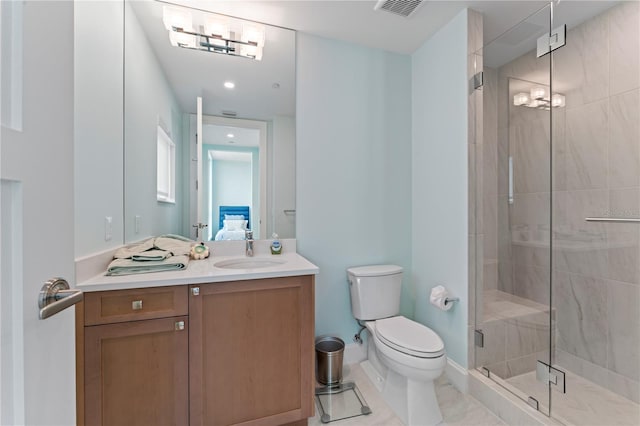 bathroom featuring tile patterned flooring, walk in shower, vanity, and toilet