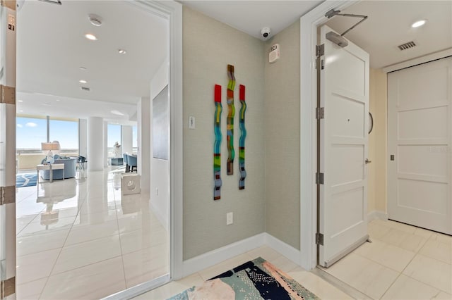 hall featuring light tile patterned flooring