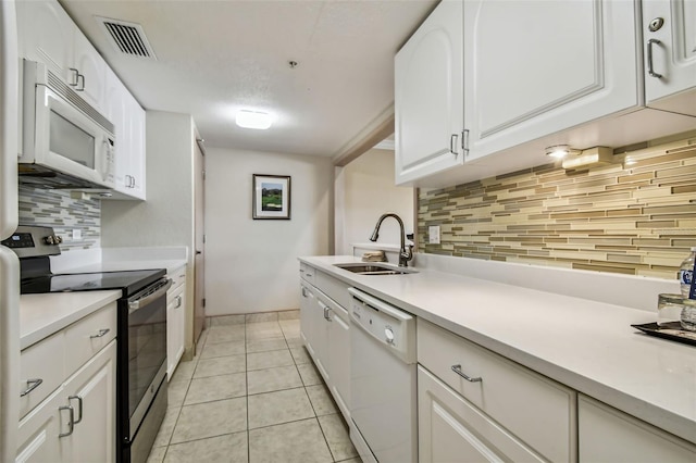 36750 US Highway 19 N Unit 04308, Palm Harbor, FL 34684 - kitchen featuring backsplash, visible vents, a sink, white appliances, and white cabinetry