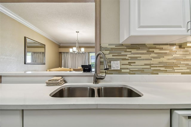 36750 US Highway 19 N Unit 04308, Palm Harbor, FL 34684 - details with a sink, a textured ceiling, tasteful backsplash, light countertops, and ornamental molding