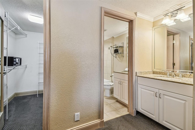 36750 US Highway 19 N Unit 04308, Palm Harbor, FL 34684 - full bath with a textured ceiling, vanity, toilet, ornamental molding, and tile patterned flooring