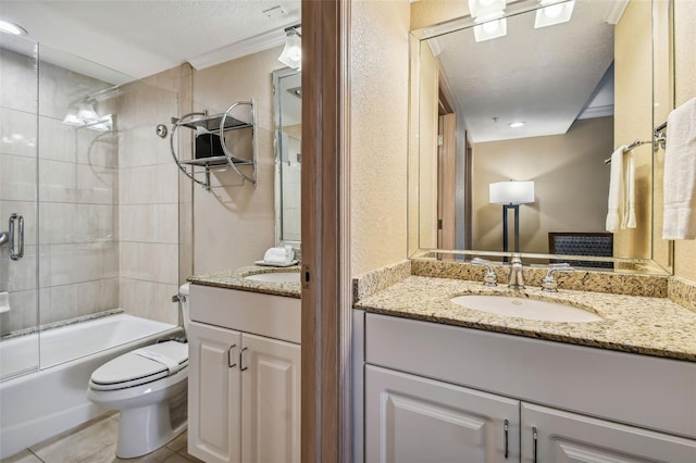 36750 US Highway 19 N Unit 04308, Palm Harbor, FL 34684 - full bathroom with tile patterned floors, a textured ceiling, toilet, vanity, and enclosed tub / shower combo